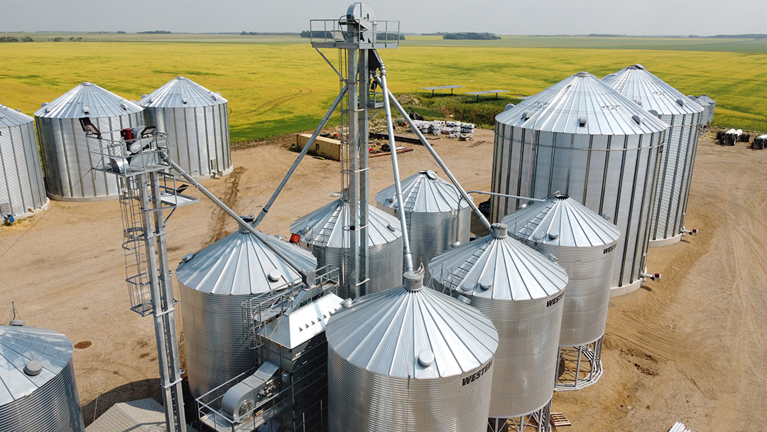 Grain Handling Site with galvanized bins, bucket elevator, and grain dryer